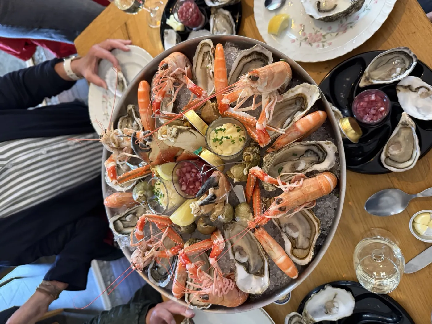 A shared seafood platter of oysters, langoustines and whelks on ice